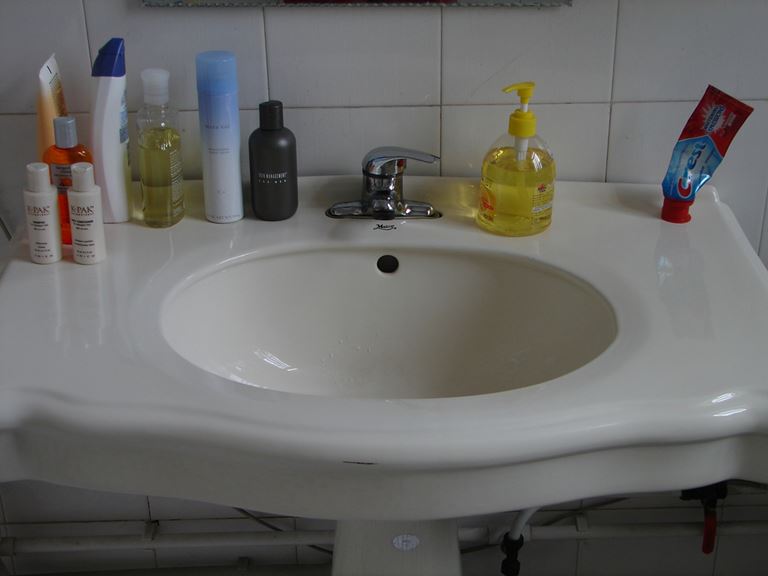 Clean washbasin with toiletries